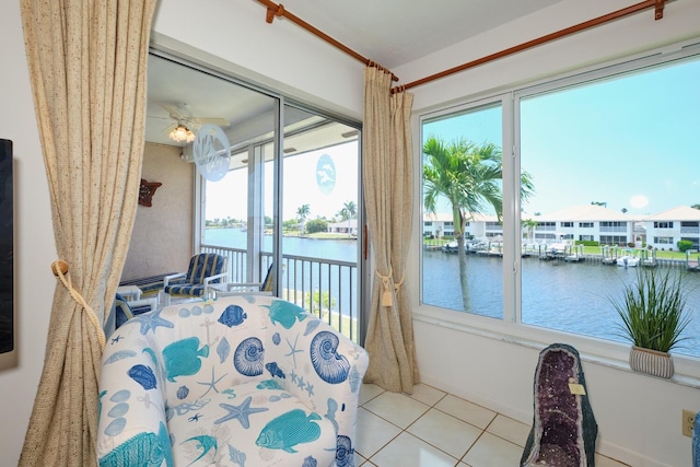 bedroom featuring tile flooring, access to exterior, and a water view