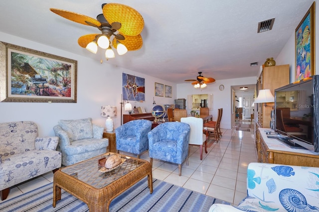 living room featuring ceiling fan and light tile floors