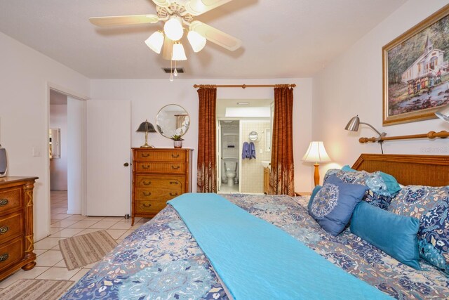 tiled bedroom featuring ceiling fan and ensuite bathroom