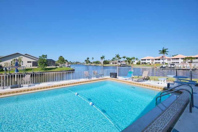 view of swimming pool featuring a water view