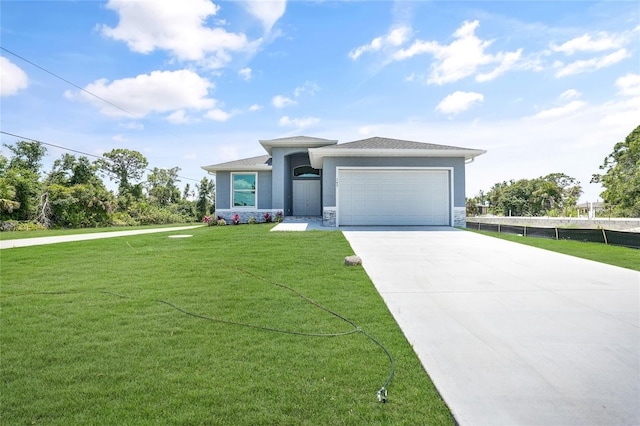 view of front of home featuring a garage and a front yard