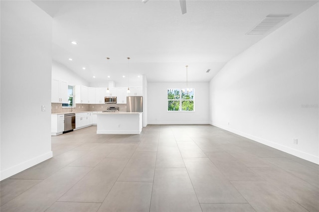 unfurnished living room with lofted ceiling, light tile floors, and a notable chandelier