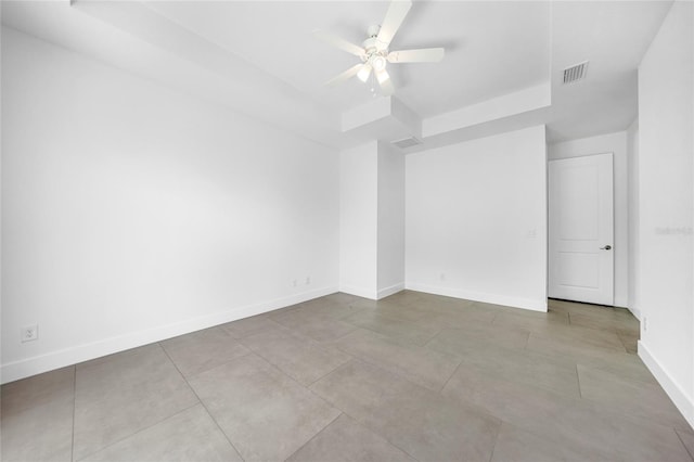 unfurnished room with a raised ceiling and ceiling fan