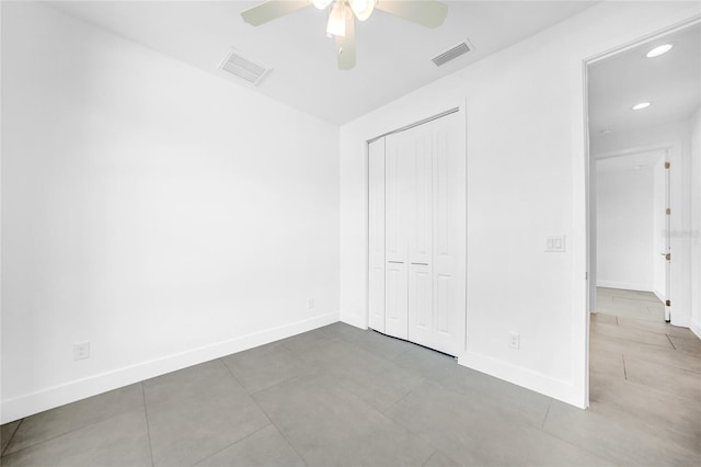 unfurnished bedroom featuring tile patterned floors, a closet, and ceiling fan