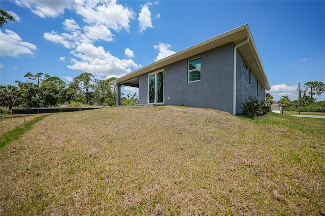 rear view of house featuring a lawn