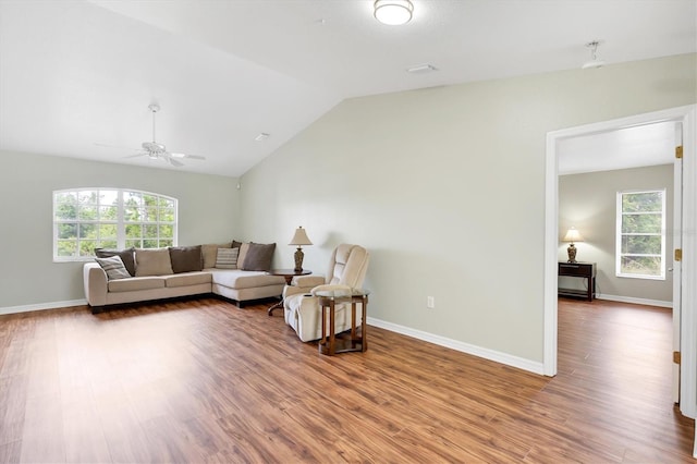 living room with lofted ceiling, wood-type flooring, and a wealth of natural light