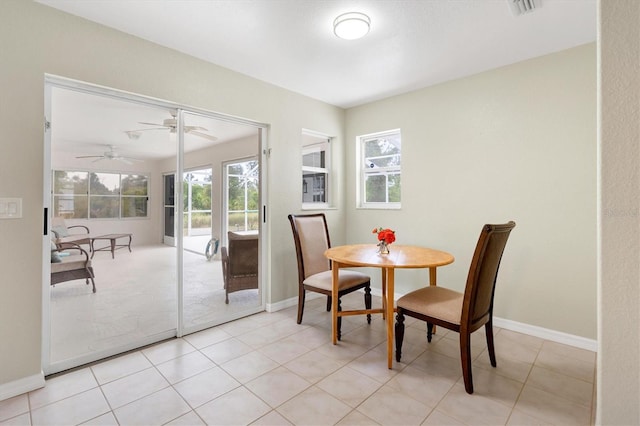 tiled dining space with ceiling fan