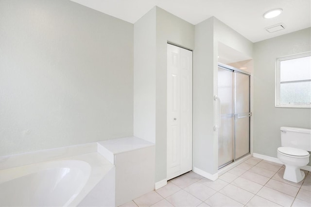 bathroom featuring plus walk in shower, tile patterned floors, and toilet