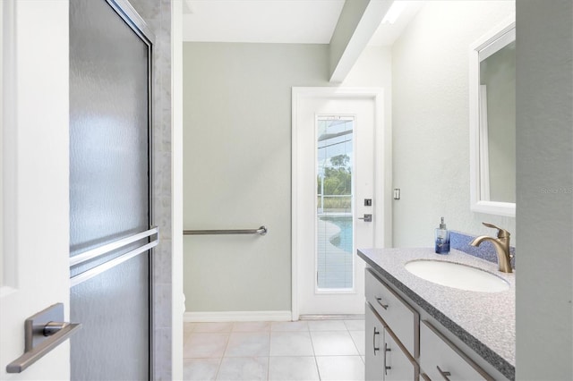 bathroom with tile patterned flooring, vanity, and a shower with shower door