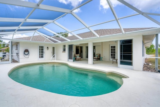 view of swimming pool with a lanai and a patio area