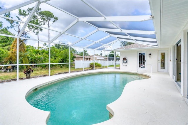 view of pool featuring glass enclosure and a patio area