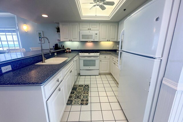 kitchen with white appliances, white cabinets, sink, ceiling fan, and light tile floors