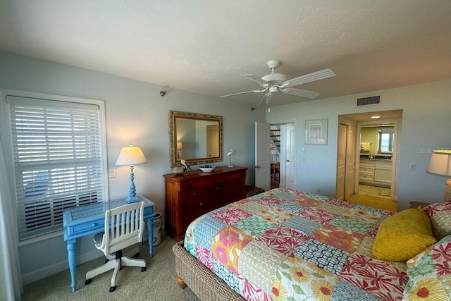 bedroom with connected bathroom, carpet, and ceiling fan