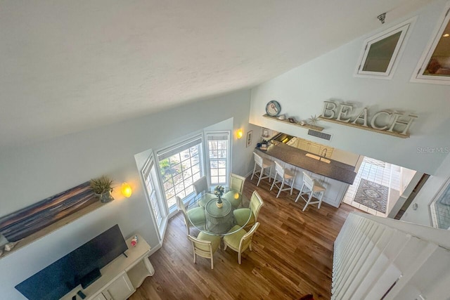 living room with dark hardwood / wood-style floors and vaulted ceiling