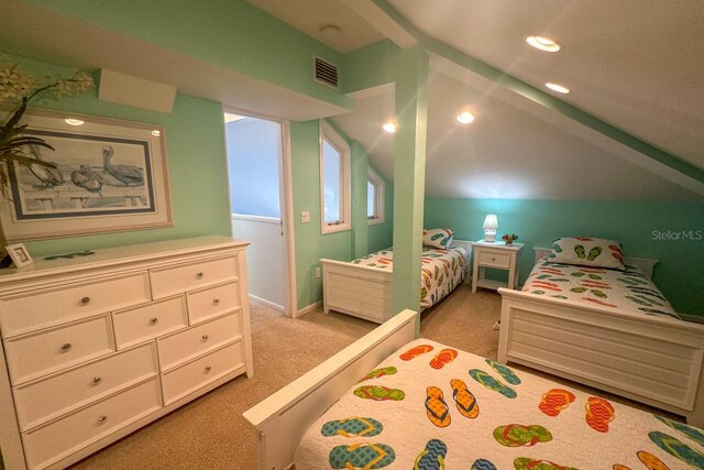 carpeted bedroom featuring lofted ceiling with beams