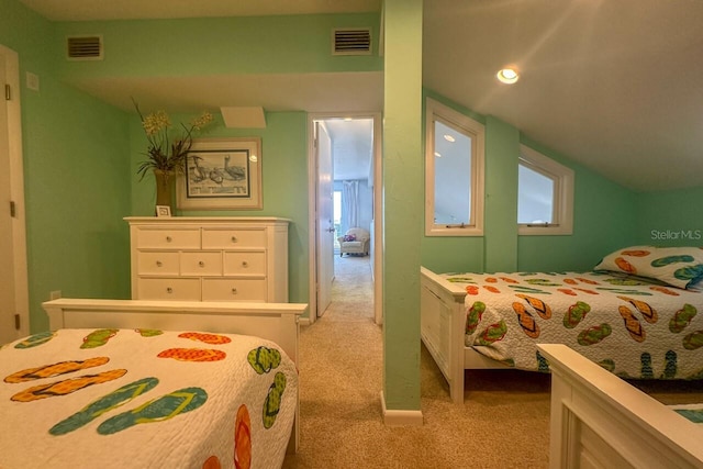 carpeted bedroom with lofted ceiling