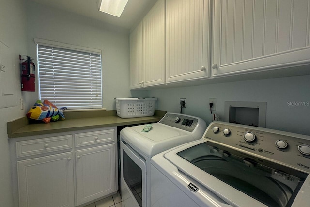 clothes washing area with separate washer and dryer, cabinets, hookup for a washing machine, electric dryer hookup, and light tile floors