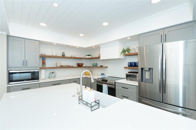 kitchen with sink, appliances with stainless steel finishes, and backsplash