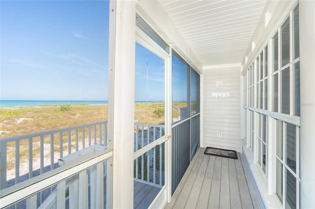 sunroom / solarium with a water view