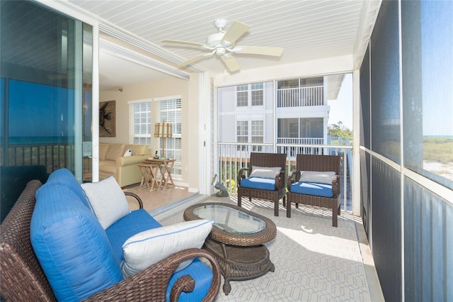 sunroom / solarium featuring ceiling fan