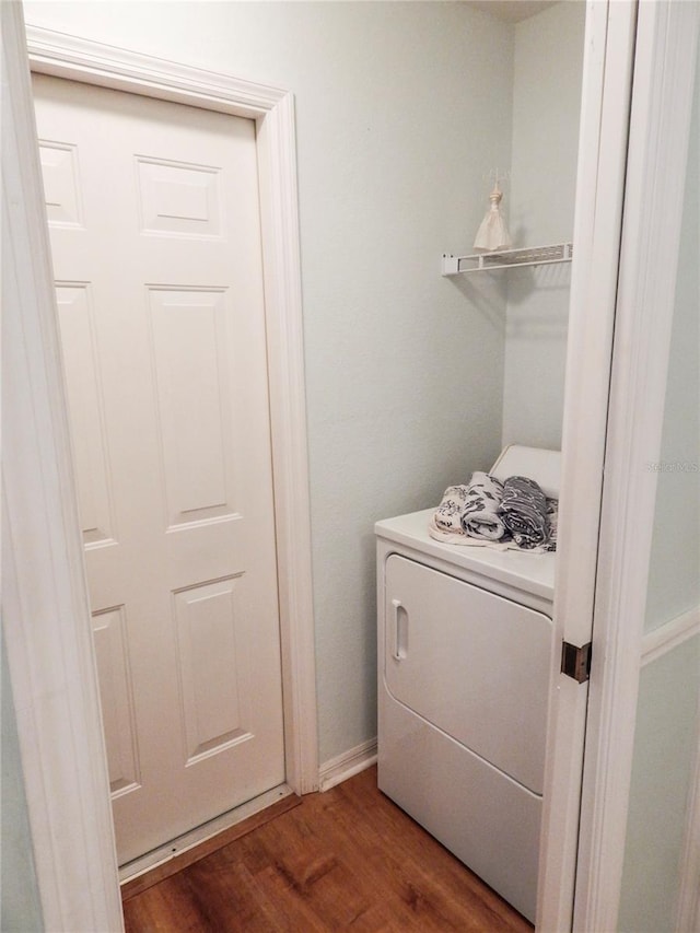 washroom with dark wood-type flooring and washer / dryer