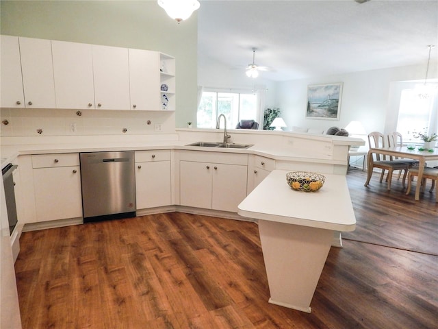 kitchen with sink, dishwasher, dark hardwood / wood-style floors, kitchen peninsula, and backsplash