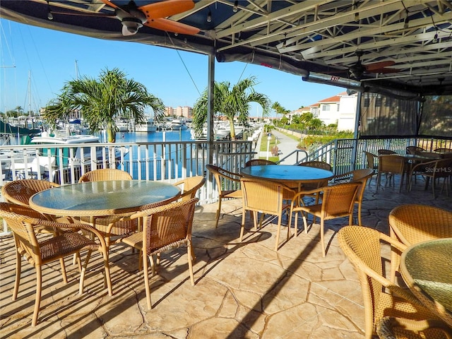 view of patio / terrace featuring a water view and ceiling fan