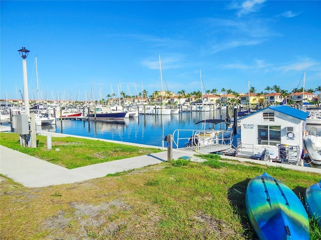 view of dock featuring a water view and a lawn