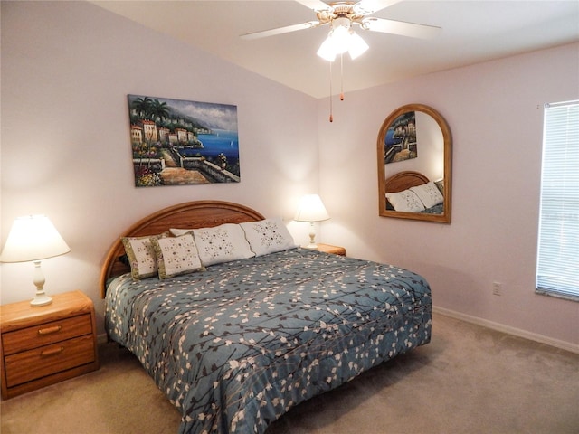 bedroom with vaulted ceiling, ceiling fan, and carpet flooring