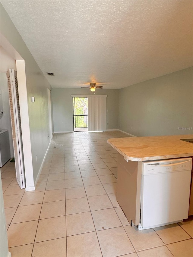 kitchen with a textured ceiling, ceiling fan, light tile patterned floors, and white dishwasher