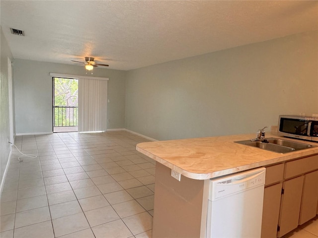 kitchen with sink, a textured ceiling, light tile patterned floors, white dishwasher, and ceiling fan