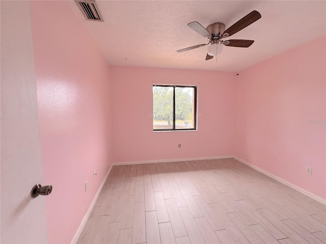 spare room featuring ceiling fan and a textured ceiling