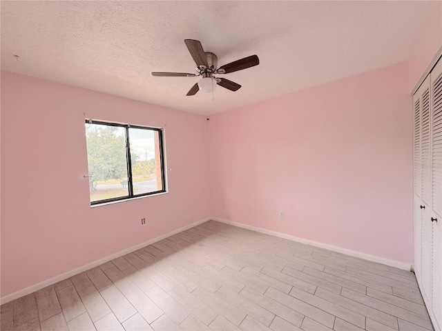 unfurnished bedroom featuring ceiling fan, a closet, and a textured ceiling