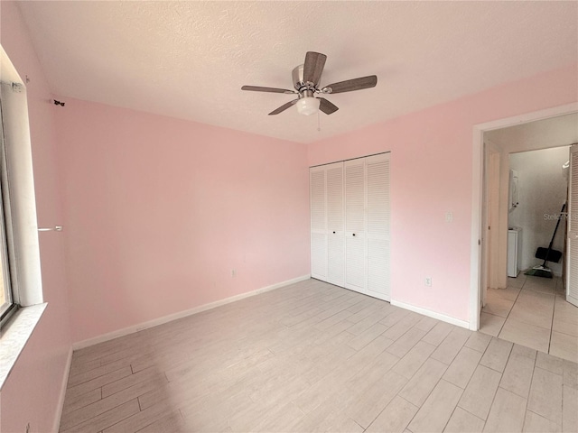 unfurnished bedroom with a textured ceiling, a closet, ceiling fan, and light tile patterned floors