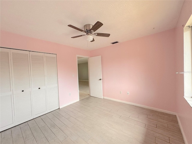 unfurnished bedroom featuring a closet, ceiling fan, and light hardwood / wood-style flooring