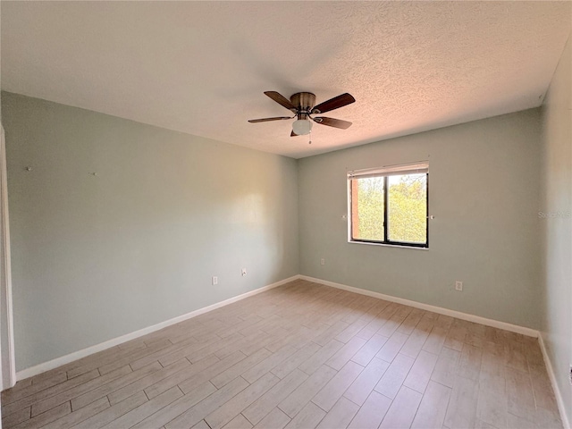 spare room featuring ceiling fan, a textured ceiling, and light hardwood / wood-style floors