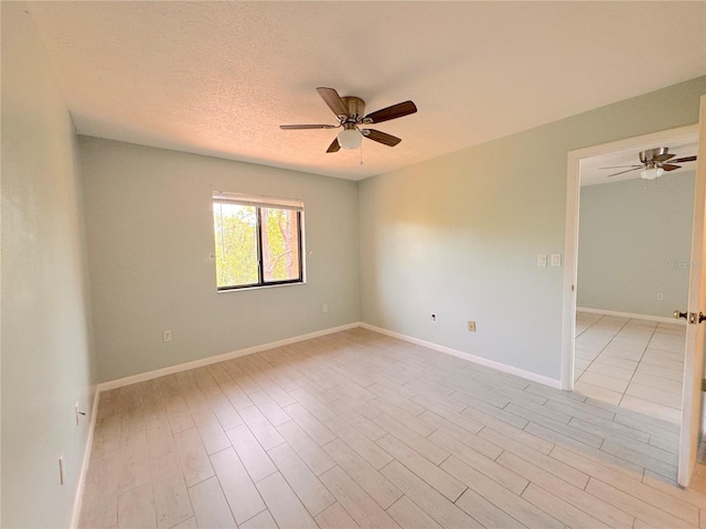 unfurnished room with a textured ceiling and ceiling fan