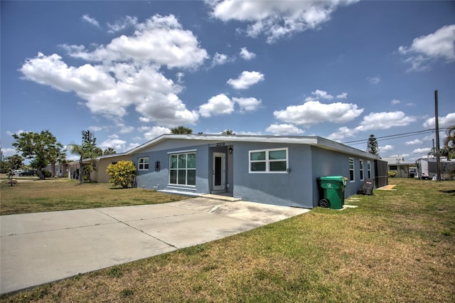 exterior space featuring a front lawn and a patio