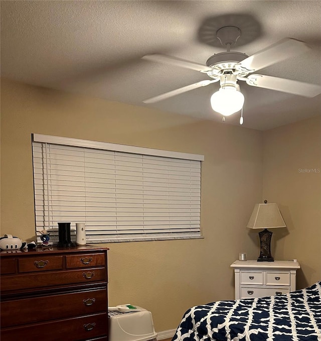 bedroom featuring a textured ceiling and ceiling fan