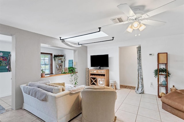 tiled living room with ceiling fan