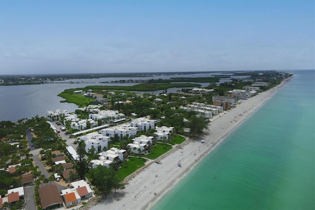 drone / aerial view with a beach view and a water view