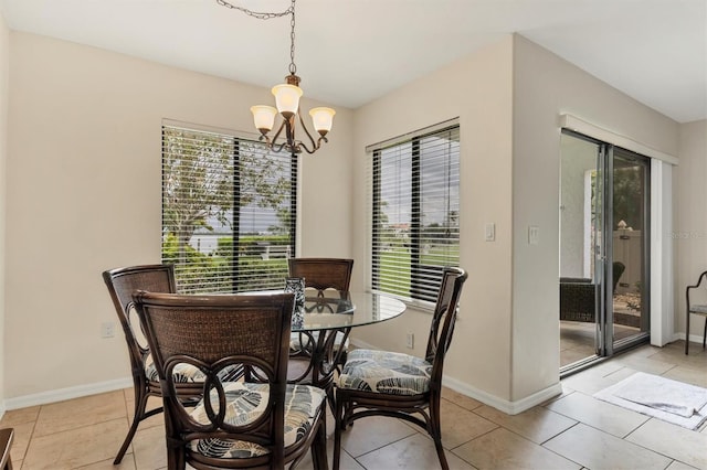 tiled dining area featuring an inviting chandelier