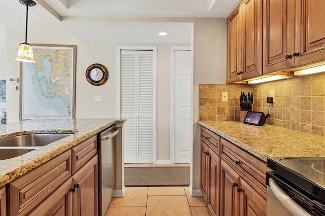 kitchen featuring stainless steel dishwasher, light stone counters, decorative light fixtures, tasteful backsplash, and light tile floors