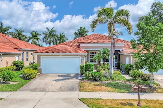 mediterranean / spanish-style house with a garage