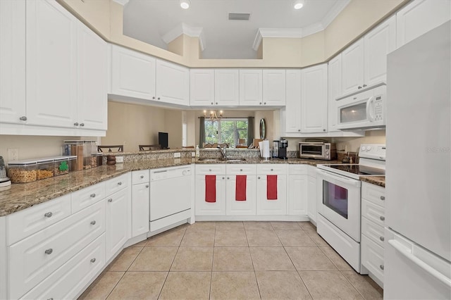 kitchen featuring white cabinetry, sink, dark stone countertops, crown molding, and white appliances