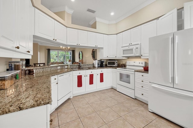 kitchen with white cabinetry, dark stone counters, white appliances, and ornamental molding