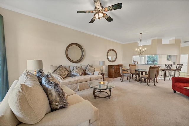 living room featuring ceiling fan with notable chandelier, light colored carpet, and crown molding