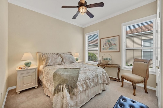 carpeted bedroom with ceiling fan and ornamental molding