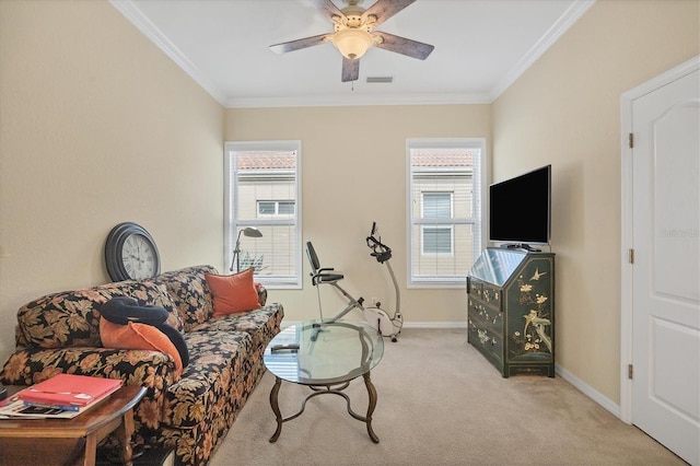 sitting room with ceiling fan, light colored carpet, and ornamental molding