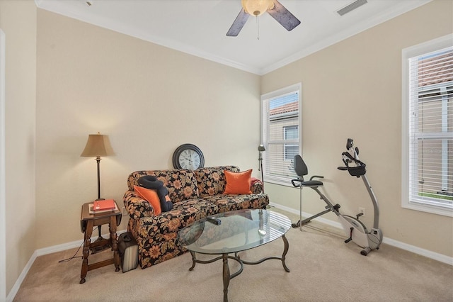 sitting room with light colored carpet, plenty of natural light, and crown molding